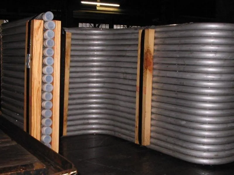 Finned tube panels standing on the shop floor after bending